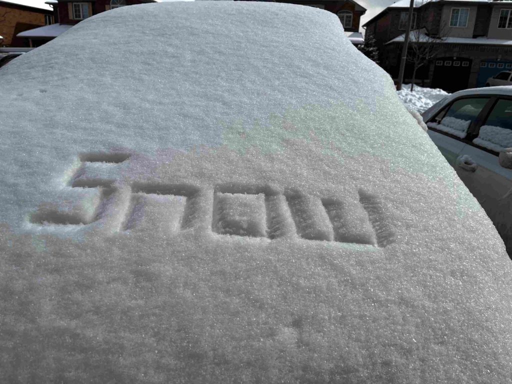 snow writing on a windshield